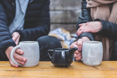 Hands and coffee cups