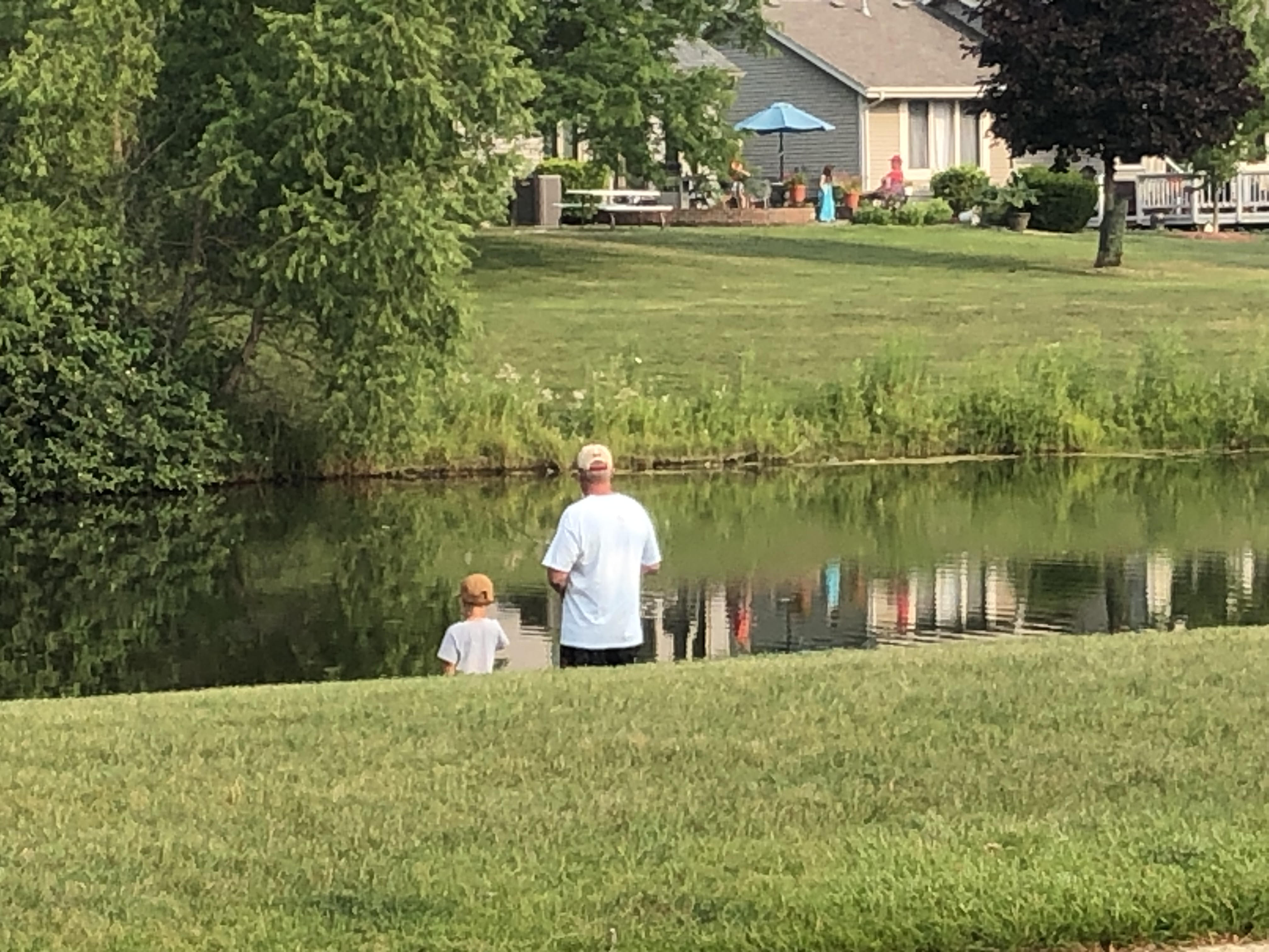 Father and son fishing in Jamestown subdivision