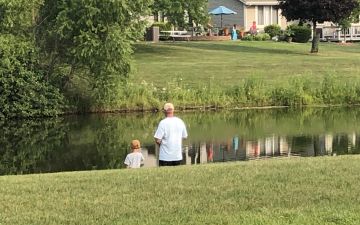 Father and son fishing in Jamestown subdivision